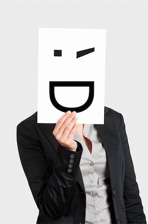 Woman showing a blank paper with a smile winking in front of her face Stock Photo - Budget Royalty-Free & Subscription, Code: 400-05717483