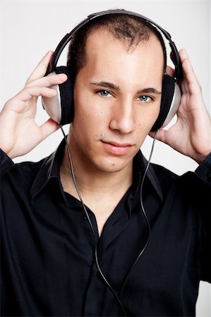 Portrait of a young man listening music with headphones Stock Photo - Budget Royalty-Free & Subscription, Code: 400-05717494