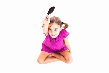 Top view of a happy girl sitting on floor holding a paint-brush Stock Photo - Budget Royalty-Free & Subscription, Code: 400-05717522