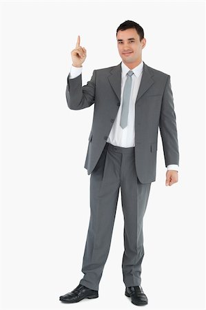 simsearch:400-05895521,k - Businessman pointing upwards against white background Stock Photo - Budget Royalty-Free & Subscription, Code: 400-05718097