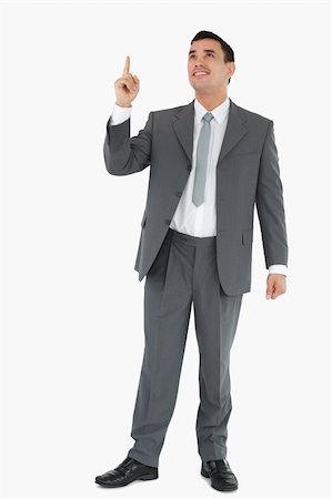simsearch:400-05895521,k - Businessman pointing and looking upwards against a white background Stock Photo - Budget Royalty-Free & Subscription, Code: 400-05718098
