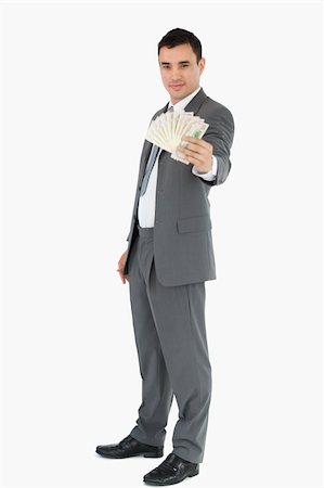 simsearch:400-05718322,k - Businessman presenting banknotes against a white background Fotografie stock - Microstock e Abbonamento, Codice: 400-05718104