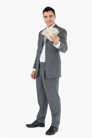 Smiling businessman presenting banknotes against a white background Stock Photo - Budget Royalty-Free & Subscription, Code: 400-05718105