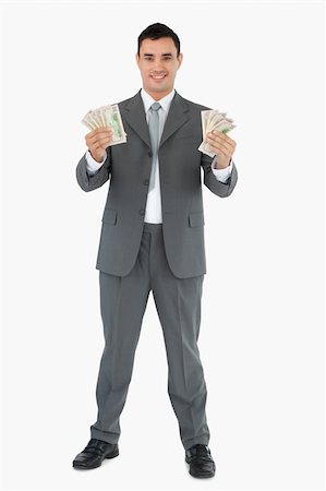 Businessman presenting banknotes with both hands against a white background Stock Photo - Budget Royalty-Free & Subscription, Code: 400-05718106