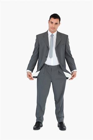 person holding their empty pockets - Businessman with empty pockets against a white background Stock Photo - Budget Royalty-Free & Subscription, Code: 400-05718100