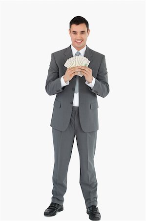 Businessman with banknotes against a white background Foto de stock - Super Valor sin royalties y Suscripción, Código: 400-05718102