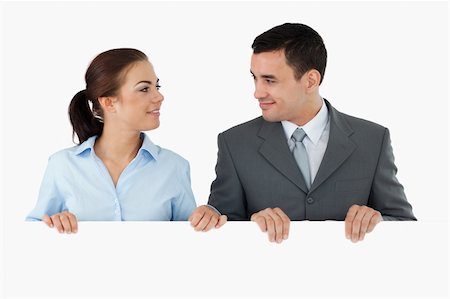 eye background for banner - Business partners looking at each other while holding sign together against a white background Stock Photo - Budget Royalty-Free & Subscription, Code: 400-05718217