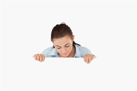 simsearch:400-05718227,k - Businesswoman looking down on sign against a white background Stock Photo - Budget Royalty-Free & Subscription, Code: 400-05718239