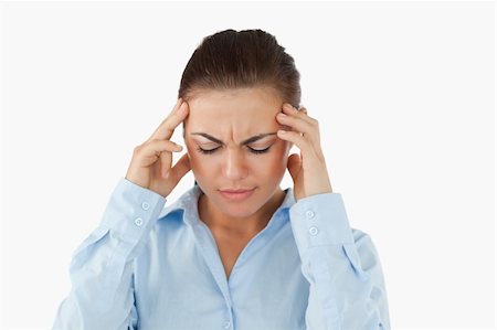 Businesswoman suffering from a headache against a white background Stock Photo - Budget Royalty-Free & Subscription, Code: 400-05718248