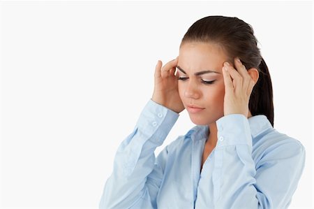 Businesswoman rubbing her temples against a white background Stock Photo - Budget Royalty-Free & Subscription, Code: 400-05718250