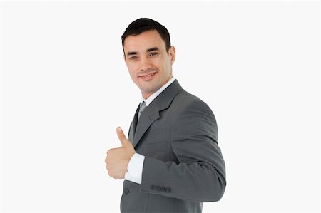 simsearch:400-05718341,k - Side view of businessman giving thumb up against a white backgroung Stock Photo - Budget Royalty-Free & Subscription, Code: 400-05718305