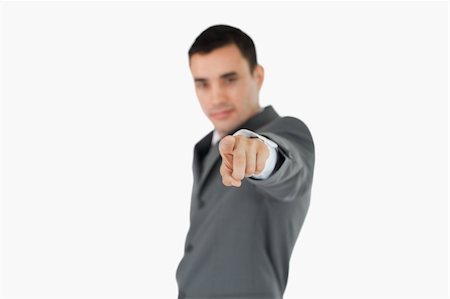 Side view of businessman pointing towards camera against a white background Stock Photo - Budget Royalty-Free & Subscription, Code: 400-05718306