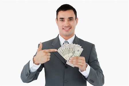 Businessman pointing at bank notes in his hand against a white background Stock Photo - Budget Royalty-Free & Subscription, Code: 400-05718324