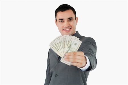 simsearch:400-05718322,k - Smiling businessman presenting bank notes against a white background Fotografie stock - Microstock e Abbonamento, Codice: 400-05718326