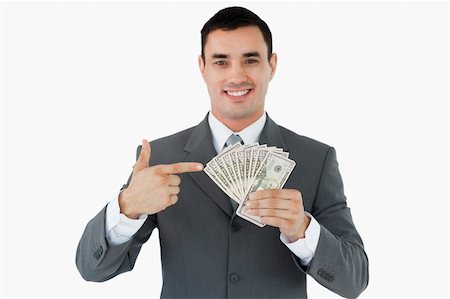 Businessman pointing at bank notes against a white background Stock Photo - Budget Royalty-Free & Subscription, Code: 400-05718323