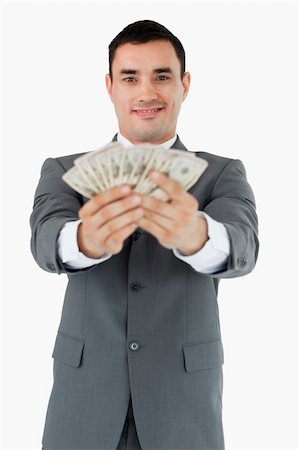 simsearch:400-05718322,k - Smiling businessman presenting his bank notes against a white background Fotografie stock - Microstock e Abbonamento, Codice: 400-05718338