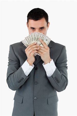 Businessman smelling bank notes against a white background Stock Photo - Budget Royalty-Free & Subscription, Code: 400-05718339