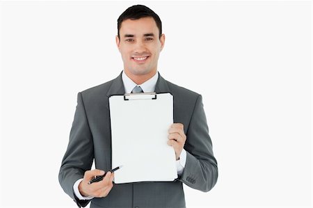 simsearch:400-08786732,k - Businessman pointing with pen on clipboard against a white background Foto de stock - Super Valor sin royalties y Suscripción, Código: 400-05718332