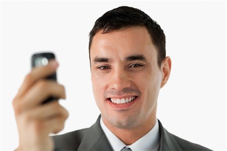 simsearch:400-05718346,k - Close up of businessman holding his cellphone against a white background Foto de stock - Super Valor sin royalties y Suscripción, Código: 400-05718404