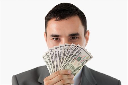 simsearch:400-05718322,k - Businessman smelling on banknotes against a white background Fotografie stock - Microstock e Abbonamento, Codice: 400-05718428