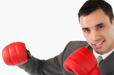 simsearch:400-04131234,k - Side view of businessman with boxing gloves against a white background Photographie de stock - Aubaine LD & Abonnement, Code: 400-05718462