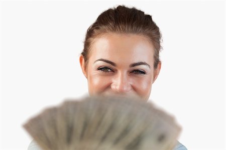 simsearch:400-05718322,k - Close up of smiling businesswoman showing her bank notes against a white background Fotografie stock - Microstock e Abbonamento, Codice: 400-05718531