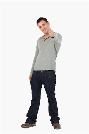 finger pointing up - Young male giving thumb up against a white background Stock Photo - Budget Royalty-Free & Subscription, Code: 400-05718544