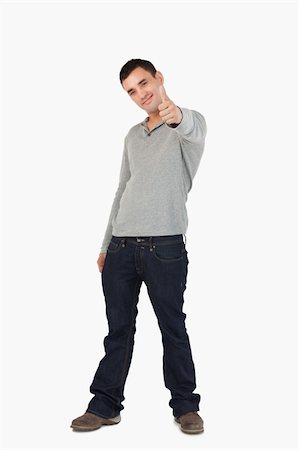 simsearch:400-05895521,k - Young guy giving thumb up against a white background Stock Photo - Budget Royalty-Free & Subscription, Code: 400-05718545