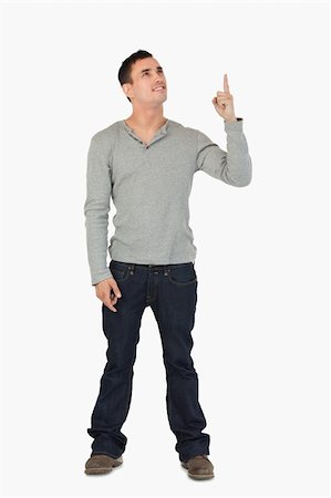 finger pointing up - Young male pointing and looking upwards against a white background Stock Photo - Budget Royalty-Free & Subscription, Code: 400-05718549