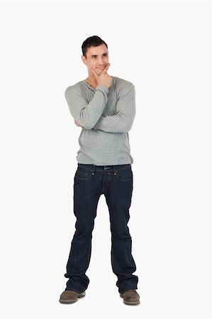simsearch:400-06795514,k - Young male standing and thinking against a white background Photographie de stock - Aubaine LD & Abonnement, Code: 400-05718551