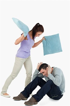 simsearch:400-04603456,k - Young female hitting her boyfriend with pillows against a white background Foto de stock - Royalty-Free Super Valor e Assinatura, Número: 400-05718605