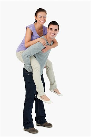 romantic carrying on shoulder - Young male carrying his girlfriend piggyback against a white background Stock Photo - Budget Royalty-Free & Subscription, Code: 400-05718606