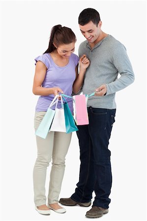 Young couple looking at their shopping against a white background Stock Photo - Budget Royalty-Free & Subscription, Code: 400-05718618