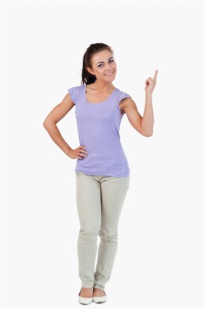 simsearch:400-05895521,k - Young female pointing upwards and smiling against a white background Stock Photo - Budget Royalty-Free & Subscription, Code: 400-05718625