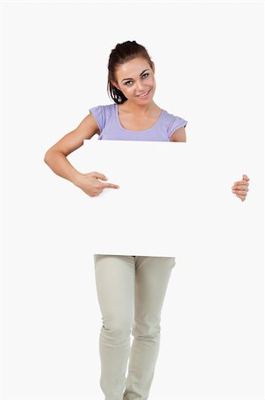 Young female pointing at banner in her hands against a white background Stock Photo - Budget Royalty-Free & Subscription, Code: 400-05718712