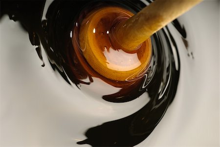 Swirling brown honey with a wooden dipper Stock Photo - Budget Royalty-Free & Subscription, Code: 400-05718918