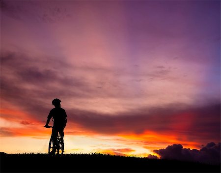 The silhouette of mountain bicycle rider on the hill with beautiful sunrise background Stock Photo - Budget Royalty-Free & Subscription, Code: 400-05718933