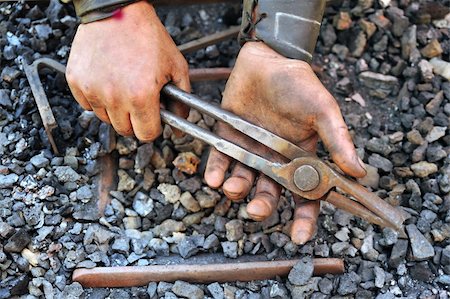 Detail of dirty hands holding pliers - blacksmith Stock Photo - Budget Royalty-Free & Subscription, Code: 400-05719090