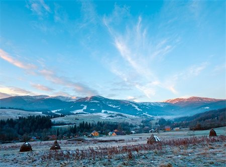 first autumn frosts on pasture with haystacks and sunrise in the mountains village Foto de stock - Super Valor sin royalties y Suscripción, Código: 400-05719577