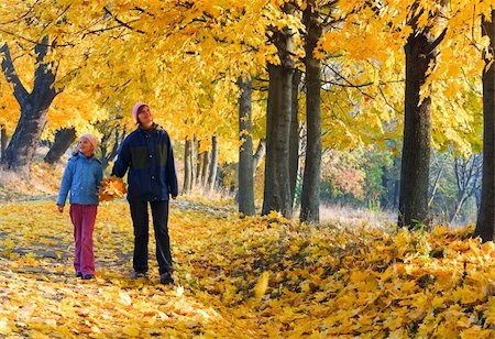 Happy family (mother with daughter) walking in golden maple autumn park Stock Photo - Budget Royalty-Free & Subscription, Code: 400-05719607