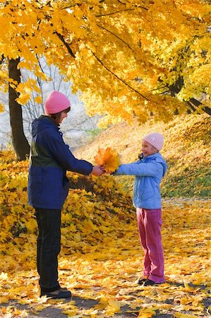 Happy family (mother with daughter) walking in golden maple autumn park Stock Photo - Budget Royalty-Free & Subscription, Code: 400-05719611