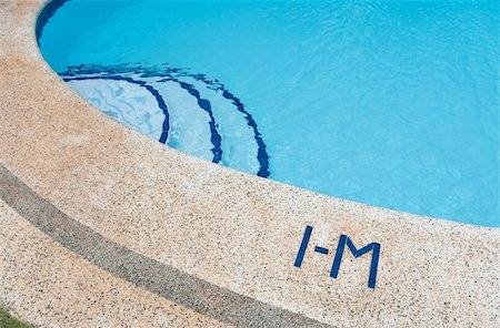 simsearch:400-07622541,k - edge of swimming pool with one meter water depth sign Stock Photo - Budget Royalty-Free & Subscription, Code: 400-05719678