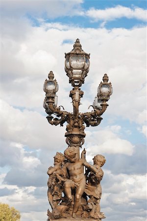 Sculpture in a streetlight in the Alexandre III bridge in Paris, France Foto de stock - Royalty-Free Super Valor e Assinatura, Número: 400-05719765