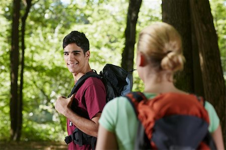 simsearch:400-06396994,k - young man and woman during hiking excursion, with man looking over shoulders. Horizontal shape, rear view, waist up Stock Photo - Budget Royalty-Free & Subscription, Code: 400-05710257