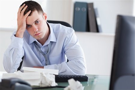 Close up of frustrated young businessman doing his accounting Stock Photo - Budget Royalty-Free & Subscription, Code: 400-05710285