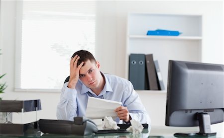 Young businessman worried about invoice Stock Photo - Budget Royalty-Free & Subscription, Code: 400-05710294