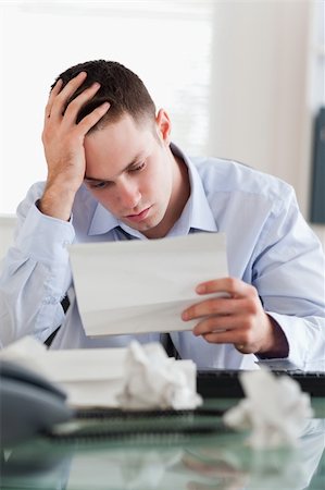 Frustrated businessman reading a bill Stock Photo - Budget Royalty-Free & Subscription, Code: 400-05710291