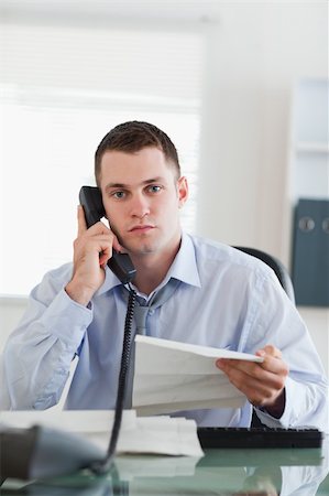 simsearch:400-05709706,k - Close up of young businessman calling the author of a letter Stock Photo - Budget Royalty-Free & Subscription, Code: 400-05710305