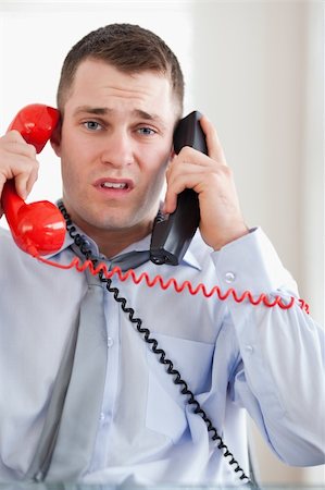 sad man talking phone - Close up of stressed businessman troubled by the telephone Stock Photo - Budget Royalty-Free & Subscription, Code: 400-05710318