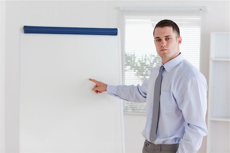 professionals whiteboard - Young businessman explaining the flip chart Stock Photo - Budget Royalty-Free & Subscription, Code: 400-05710356